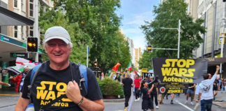 Palestine Solidarity Network Aotearoa's Neil Scott and protesters marching in the Stop Wars Aotearoa rally