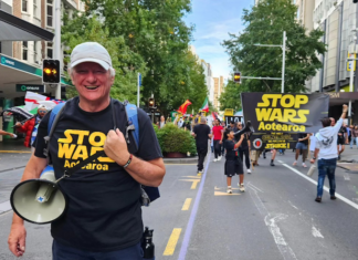 Palestine Solidarity Network Aotearoa's Neil Scott and protesters marching in the Stop Wars Aotearoa rally