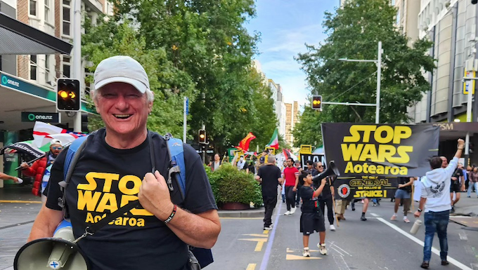 Palestine Solidarity Network Aotearoa's Neil Scott and protesters marching in the Stop Wars Aotearoa rally
