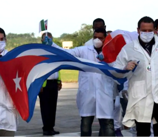The world owes Cuba a debt – and the US a condemnation Cuban doctors arriving back from Italy following the covid outbreak in 2020