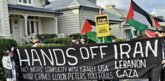 A "No more complicity with war crimes" banner at a "Stop Wars" march at Devonport
