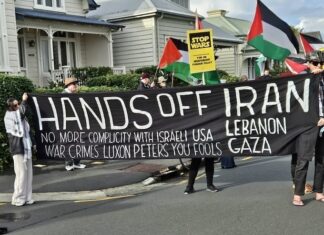 A "No more complicity with war crimes" banner at a "Stop Wars" march at Devonport
