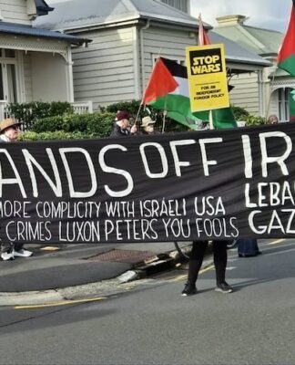 A "No more complicity with war crimes" banner at a "Stop Wars" march at Devonport