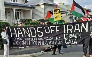 A "No more complicity with war crimes" banner at a "Stop Wars" march at Devonport