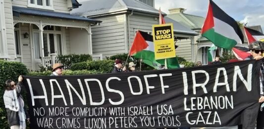 A "No more complicity with war crimes" banner at a "Stop Wars" march at Devonport