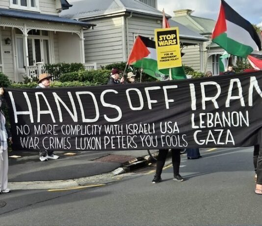 A "No more complicity with war crimes" banner at a "Stop Wars" march at Devonport