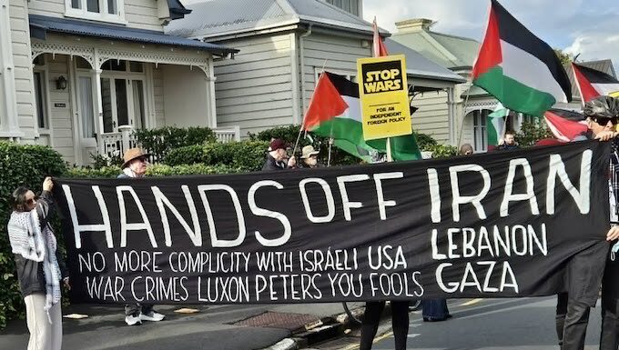 A "No more complicity with war crimes" banner at a "Stop Wars" march at Devonport