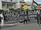 A "No more complicity with war crimes" banner at a "Stop Wars" march at Devonport