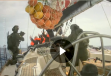 Israeli soldiers board a Gaza-bound humanitarian aid flotilla vessel and hold the crew at gunpoint