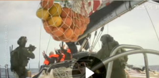 Israeli soldiers board a Gaza-bound humanitarian aid flotilla vessel and hold the crew at gunpoint