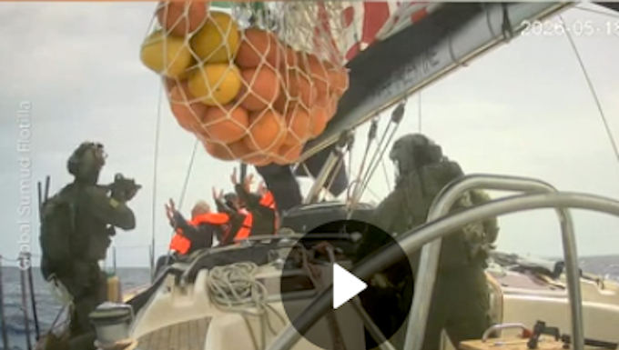 Israeli soldiers board a Gaza-bound humanitarian aid flotilla vessel and hold the crew at gunpoint
