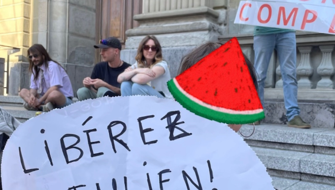 Julien Blondel's niece holds a "free Julien!" placard in French with a Palestinian watermelon logo