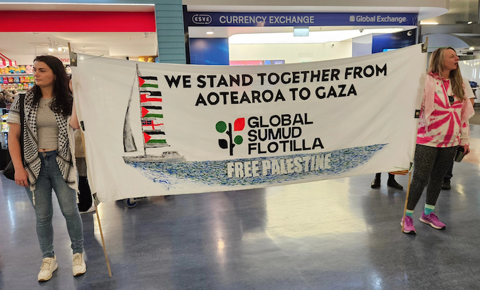 "We stand together from Aotearoa to Gaza" banner at Auckland International Airport today