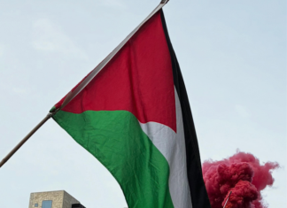 Pro-Palestine protesters set off a blood-red flare outside the US Consulate in the peaceful March for Peace demonstration in Auckland