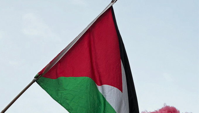 Pro-Palestine protesters set off a blood-red flare outside the US Consulate in the peaceful March for Peace demonstration in Auckland