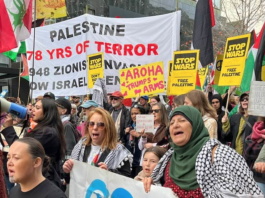 “Palestine - 78 years of [Israeli] terror” and "Aroha trumps arms" banners at the Auckland June 20 March for Peace