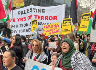 “Palestine - 78 years of [Israeli] terror” and "Aroha trumps arms" banners at the Auckland June 20 March for Peace