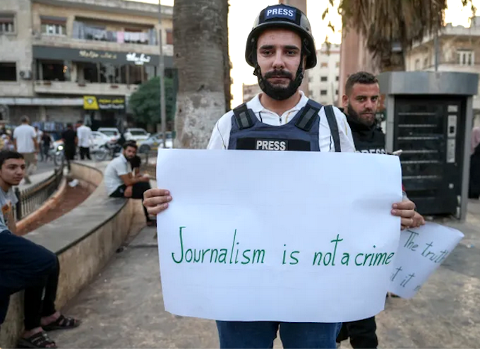 A Syrian journalist protesting over the killing of reporters in Gaza