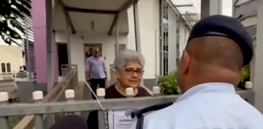 Fiji police talk to a Palestine protest organiser, Fiji Women's Crisis Centre coordinator Shamima Ali