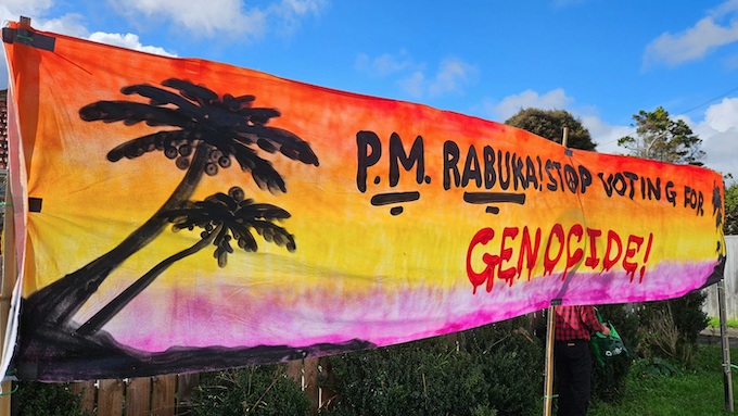 The "PM Rabuka stop voting for genocide" banner at the Auckland protest