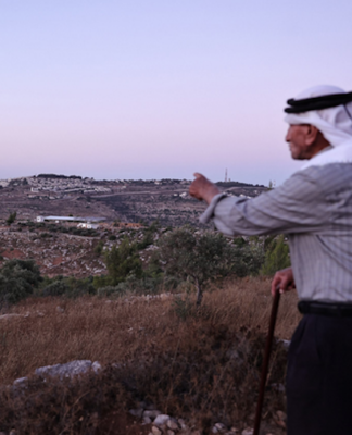 Olayan Olayan, who was born in the village of Battir in 1941, overlooks a valley in which a new Israeli settler outpost is built