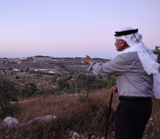 Olayan Olayan, who was born in the village of Battir in 1941, overlooks a valley in which a new Israeli settler outpost is built