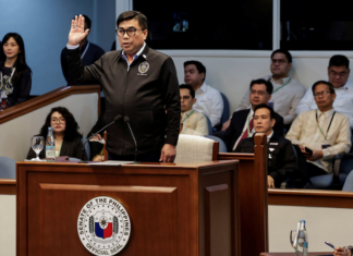 Filipino National Bureau of Investigation Director Melvin Matibag takes an oath before testifying