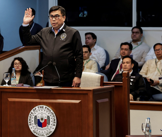 Filipino National Bureau of Investigation Director Melvin Matibag takes an oath before testifying