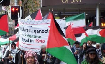 Iranian and Palestinian flags at a New Zealand rally against the war on Iran and the Gaza genocide