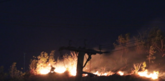 A bushfire comes close to a residential area in Hohola, Port Moresby