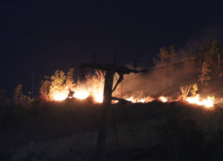 A bushfire comes close to a residential area in Hohola, Port Moresby