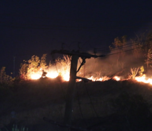 A bushfire comes close to a residential area in Hohola, Port Moresby