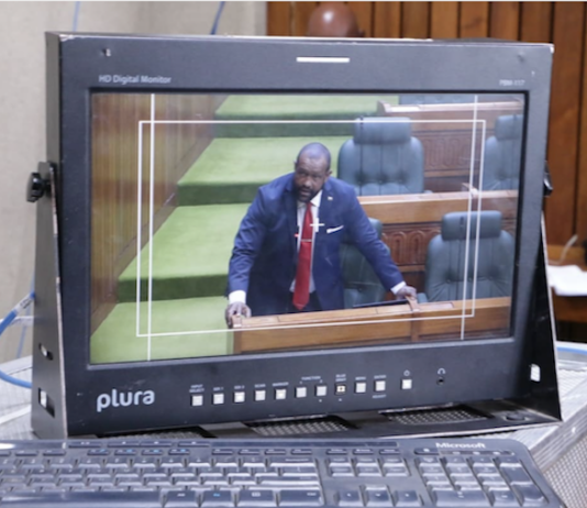 A PNG Parliament press gallery monitor shows Opposition Leader James Nomane speaking during debate following the tabling of the Bougainville referendum result