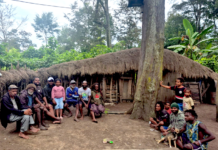 Indonesia at 81 – who owns the land of Papua’s future? The author, Laurens Ikinia, with extended whānau - family (he is pictured fourth from left)