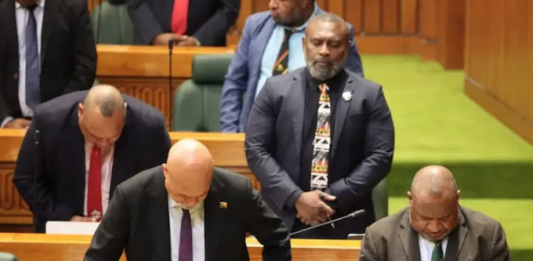 PNG Prime Minister James Marape (right) and MPs "pray for wisdom"