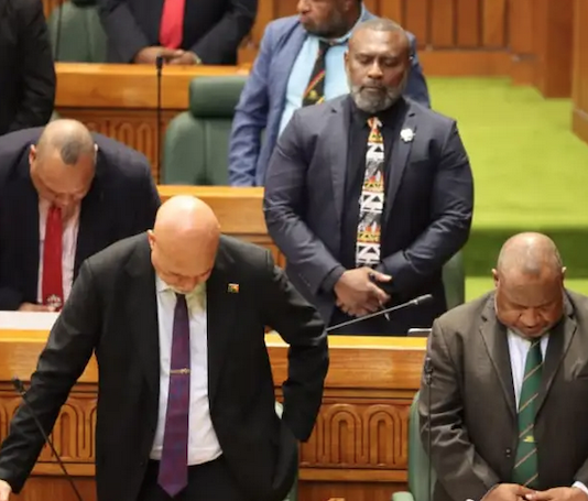 PNG Prime Minister James Marape (right) and MPs "pray for wisdom"