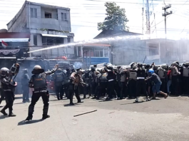 Indonesian police fire water cannon and tear gas on West Papuan demonstrators at Perumnas III Waena, Heram District, Jayapura City, Papua