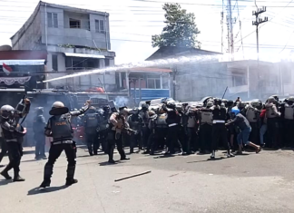 Indonesian police fire water cannon and tear gas on West Papuan demonstrators at Perumnas III Waena, Heram District, Jayapura City, Papua