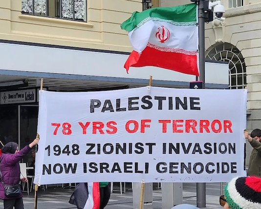 A banner at today's rally in Auckland's Te Komititanga Square