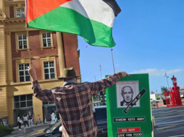 Protester Craig Tynan "shows the flag"