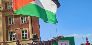 Protester Craig Tynan "shows the flag"