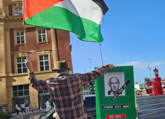 Protester Craig Tynan "shows the flag"