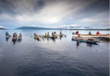 Islanders in outrigger canoes selling tropical fruits off Dobu in the Solomon Sea