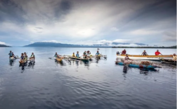 Debt in the Pacific – systemic and current threats to regional economic sovereignty Islanders in outrigger canoes selling tropical fruits off Dobu in the Solomon Sea