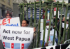 West Papuan activist Paula Makabory (centre, holding banner) at a protest in Auckland in 2011
