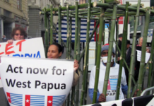 West Papuan activist Paula Makabory (centre, holding banner) at a protest in Auckland in 2011