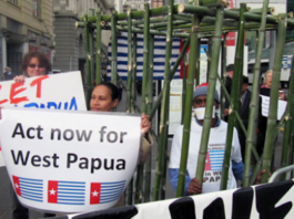 West Papuan activist Paula Makabory (centre, holding banner) at a protest in Auckland in 2011