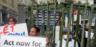 West Papuan activist Paula Makabory (centre, holding banner) at a protest in Auckland in 2011
