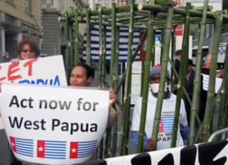 West Papuan activist Paula Makabory (centre, holding banner) at a protest in Auckland in 2011