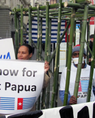 West Papuan activist Paula Makabory (centre, holding banner) at a protest in Auckland in 2011